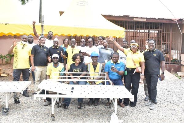 MTN Staff in a group picture with one of the refurbished beds