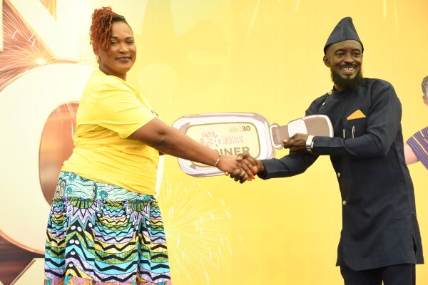 Chief Customer Experience Officer of MTN Ghana, Jemima Kotei Walsh (left), presenting a symbolic key to Cephas Kwadwo Mensah Daben