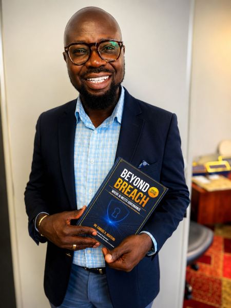 Dr. Samuel Boateng, founder and CEO of Slamm Technologies, with copy of the newly launched book ‘Beyond Breach Where AI
